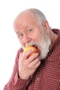 Cheerfull senior man eating the apple, isolated on white Royalty Free Stock Photo