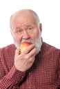 Cheerfull senior man eating the apple, isolated on white Royalty Free Stock Photo