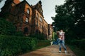 Cheerfully hugging loving couple. The young man is spinning his girlfrind round near the architecture in Poland.