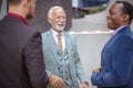 Three business men talking. Focus is on background