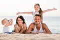 parents with two kids lying on the beach. Royalty Free Stock Photo