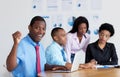 Cheering african american businessman with business team at office Royalty Free Stock Photo