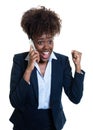 Cheering african american businesswoman at phone