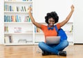 Cheering african american female student at video call at computer