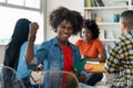 Cheering african american male college student at desk at classroom Royalty Free Stock Photo