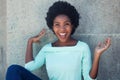 Cheering african american woman in a light green shirt Royalty Free Stock Photo