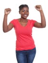 Cheering african american woman in a red shirt and jeans