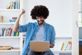 Cheering afro american hipster man in quarantine at computer Royalty Free Stock Photo