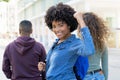 Cheering black female student with backpack and friends Royalty Free Stock Photo