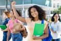 Cheering black female student with group of latin american and caucasian young adults Royalty Free Stock Photo