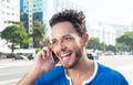 Cheering brazilian man at phone at city Royalty Free Stock Photo