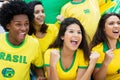 Cheering brazilian soccer fans with flag at stadium Royalty Free Stock Photo