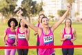 Cheering brunette winning breast cancer marathon Royalty Free Stock Photo