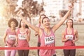 Cheering brunette winning breast cancer marathon Royalty Free Stock Photo