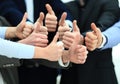 Cheering business people holding many thumbs thumbs up Royalty Free Stock Photo