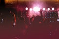 cheering crowd in front of bright red stage lights. Silhouette image of people dance in disco night club or concert at a Royalty Free Stock Photo