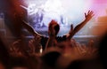 Cheering crowd in front of bright stage lights