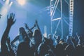 cheering crowd with raised hands at concert - music festival