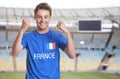 Cheering fan from France in sports jersey at soccer stadium Royalty Free Stock Photo