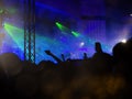 Cheering fans raising their hands on the beat in a free live concert in music festival Royalty Free Stock Photo