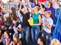 Cheering fans in stadium holding champion banner. Royalty Free Stock Photo