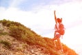 Cheering happy asian woman hiker at mountain peak