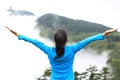 Cheering hiking woman enjoy the beautiful view at mountain peak Royalty Free Stock Photo