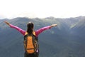 Cheering hiking woman enjoy the beautiful view at mountain peak Royalty Free Stock Photo