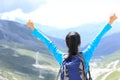 Cheering hiking woman enjoy the beautiful view at mountain peak Royalty Free Stock Photo