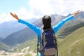 Cheering hiking woman enjoy the beautiful view at mountain peak Royalty Free Stock Photo