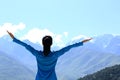 Cheering hiking woman enjoy the beautiful view at mountain peak Royalty Free Stock Photo