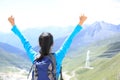 Cheering hiking woman enjoy the beautiful view at mountain peak in tibet,china Royalty Free Stock Photo