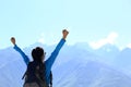 Cheering hiking woman enjoy the beautiful view at mountain peak in tibet,china Royalty Free Stock Photo
