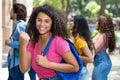 Cheering hispanic female university student with group of caucasian and african american young adults Royalty Free Stock Photo