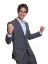 Cheering latin businessman with suit and short hair