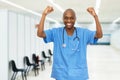 Cheering mature adult african american male nurse at vaccination station for vacinating patients