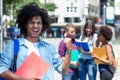 Cheering mexican male student with other young adults