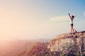 Cheering woman hiker open arms at mountain peak Royalty Free Stock Photo
