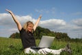 A cheering woman with a laptop