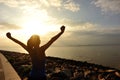 Cheering woman open arms on beach Royalty Free Stock Photo