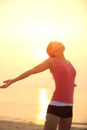 Cheering woman open arms on beach Royalty Free Stock Photo