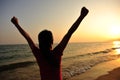 Cheering woman open arms on beach Royalty Free Stock Photo