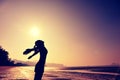 Cheering woman open arms on beach