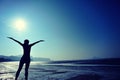 Cheering woman open arms on beach Royalty Free Stock Photo