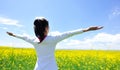 Cheering woman open arms at cole flower field Royalty Free Stock Photo