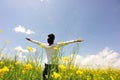 Cheering woman open arms at cole flower field Royalty Free Stock Photo