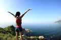 Cheering young fitness woman open arms on seaside Royalty Free Stock Photo