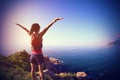 Cheering young fitness woman open arms on seaside Royalty Free Stock Photo