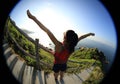 Cheering young fitness woman trail runner open arms Royalty Free Stock Photo