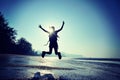 Cheering young woman hiker jumping Royalty Free Stock Photo